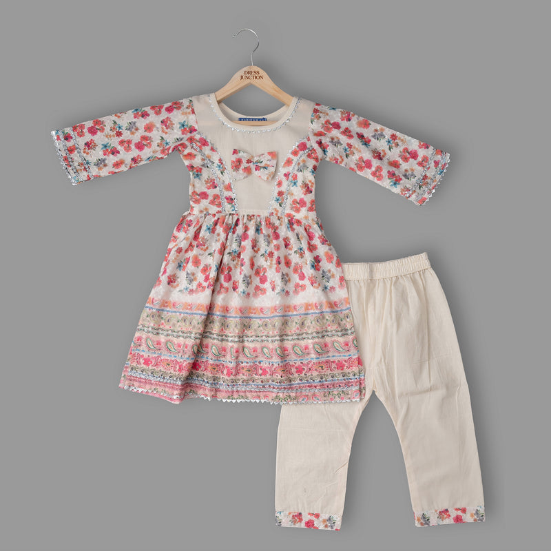 Floral dress and beige pants set on a gray background