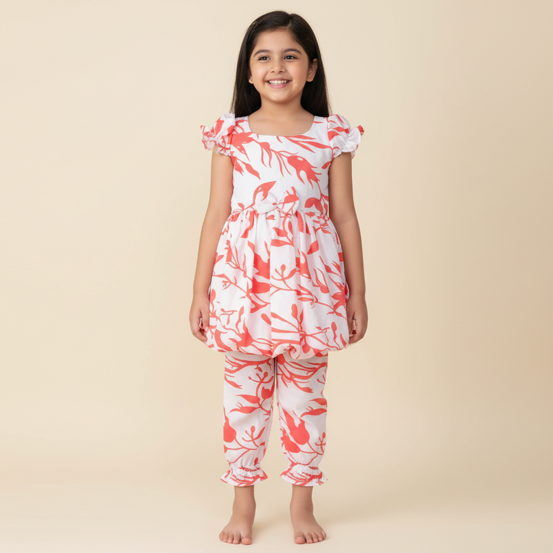 Young girl wearing a white outfit with red floral patterns on a beige background