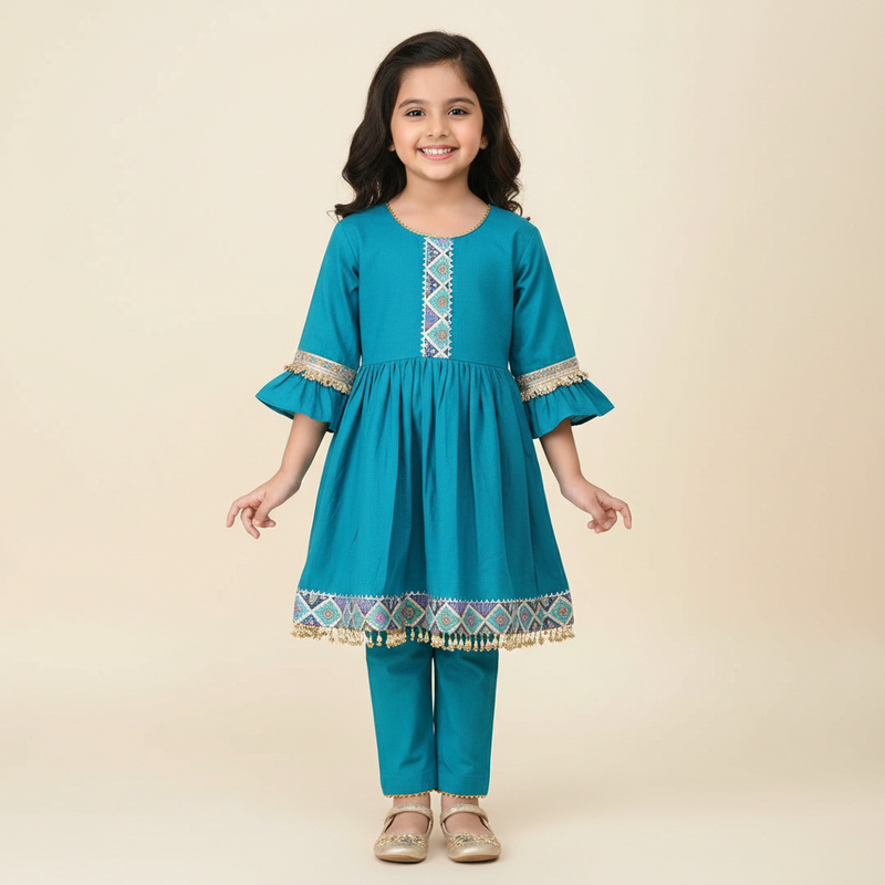 Teal children's outfit with decorative patterns on a gray background
