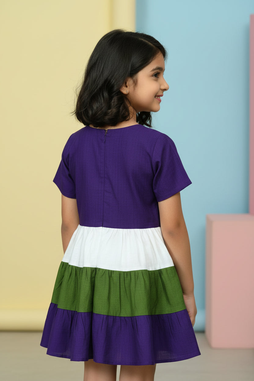 Color-blocked dress with purple, green, and white on a yellow fabric background