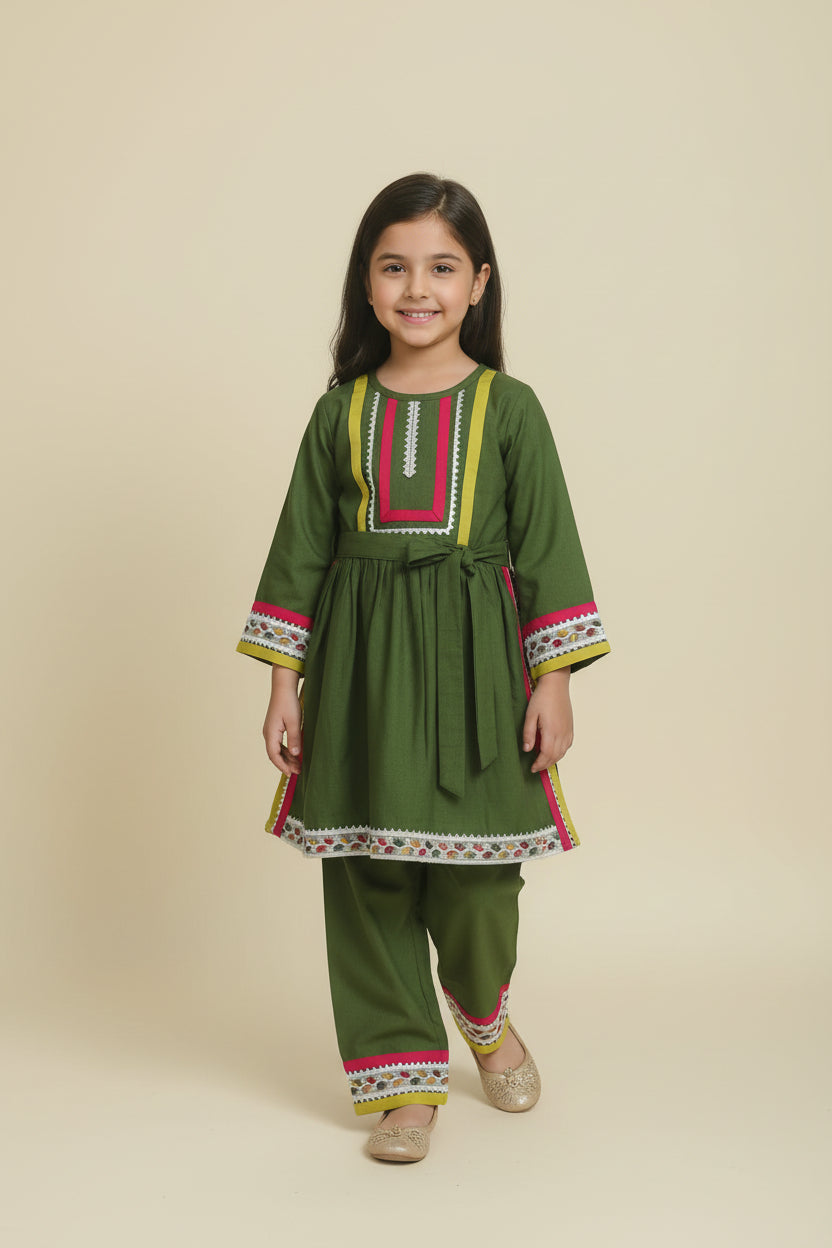 Traditional green outfit with intricate patterns on a white background