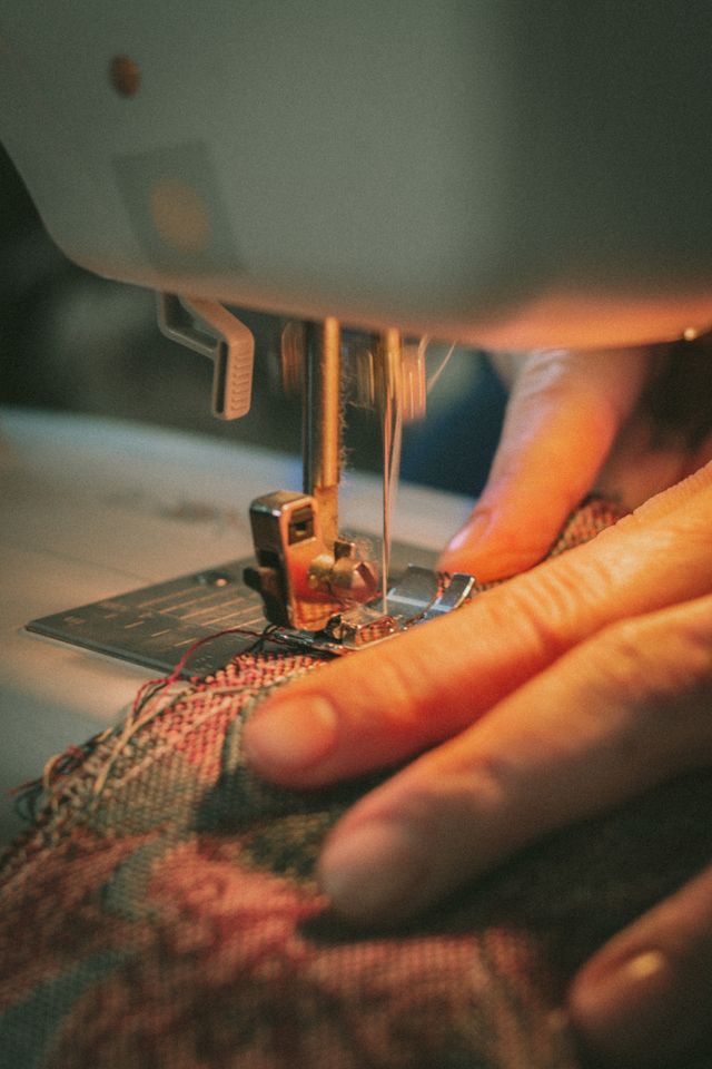 Close-up of a worker crafting a garment on a machine