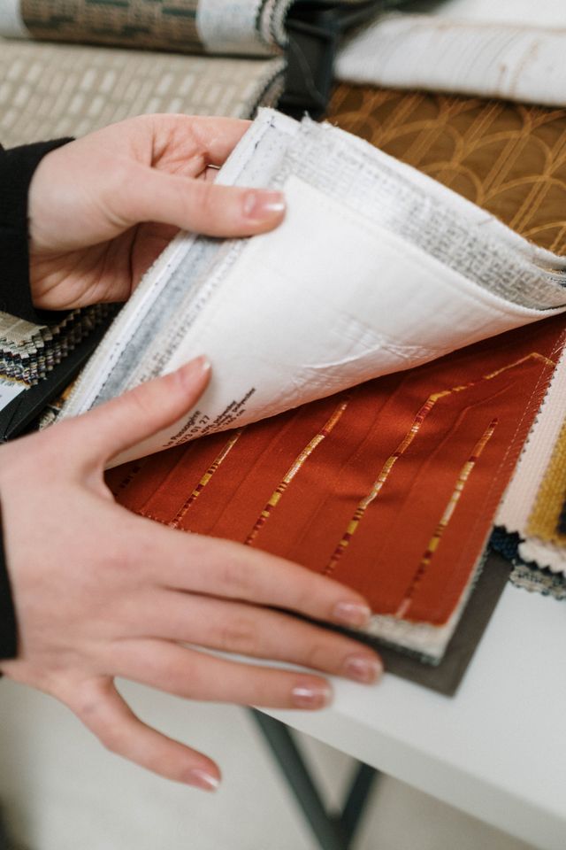 Close-up of hand touching selected fabric